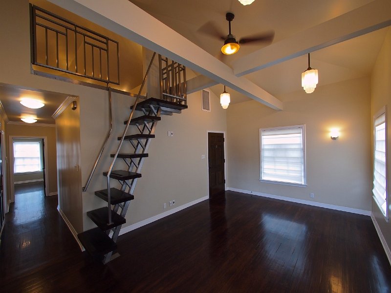 The livingroom with hall to the left, front door to the right and loft ladder 